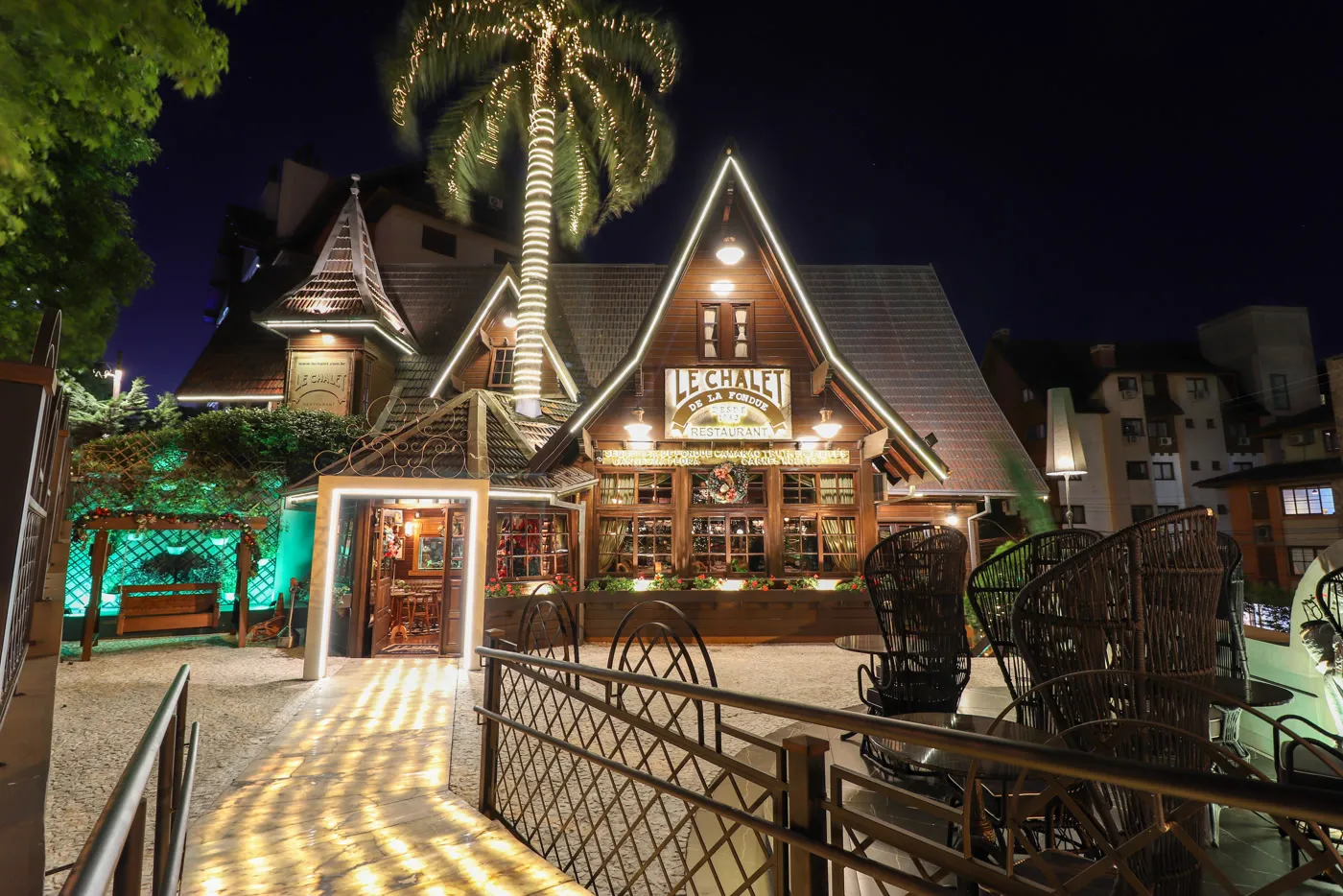 Le Chalet de la Fondue restaurant facade illuminated at night in Gramado, Brazil