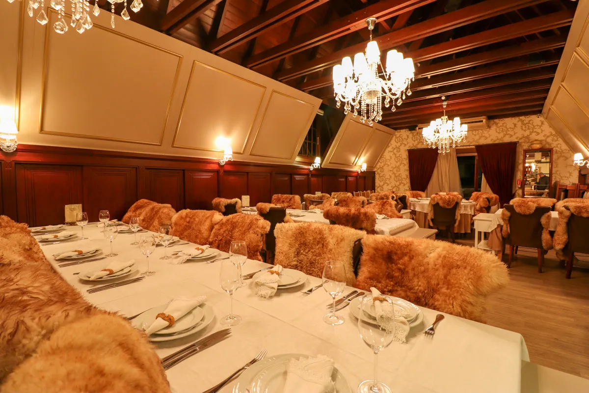 Le Chalet dining room with sheepskins and crystal chandeliers